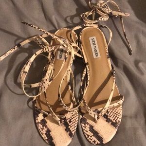 Lace up snake print sandals.